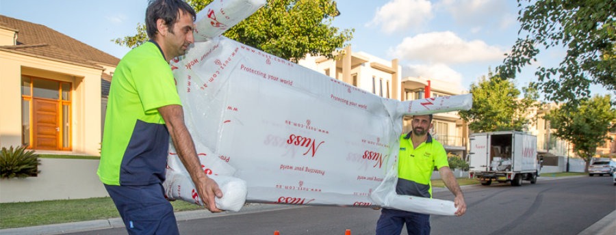 sydney removalists moving a large table into the moving truck