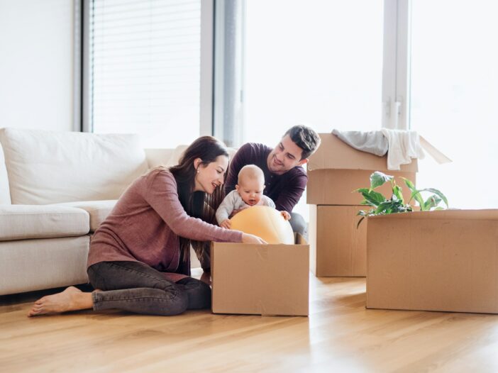 Parents with their baby removing a soft ball out of a box